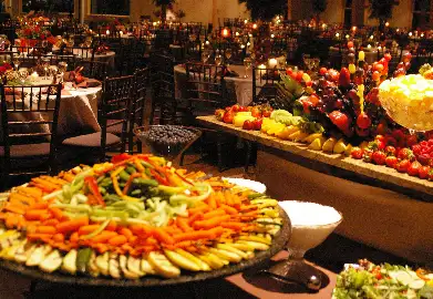 Wedding buffet with a vegetable platter and decorated fruit display