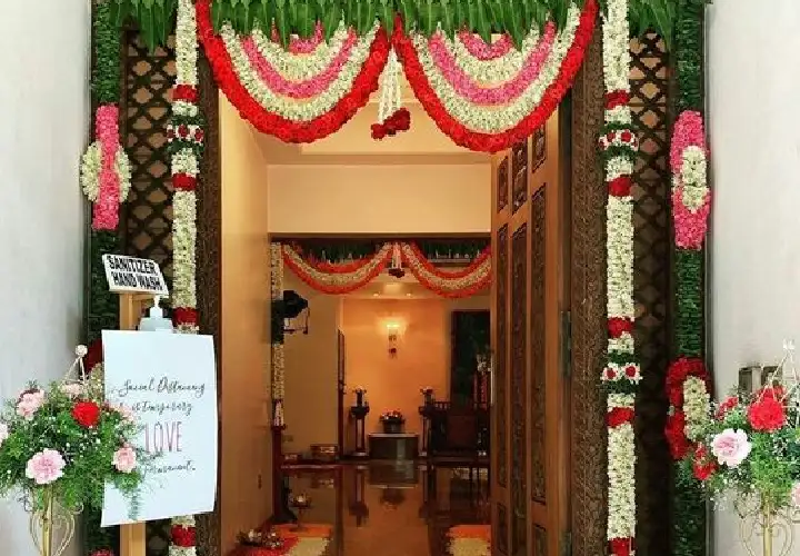 Housewarming entrance decorated with flower garlands